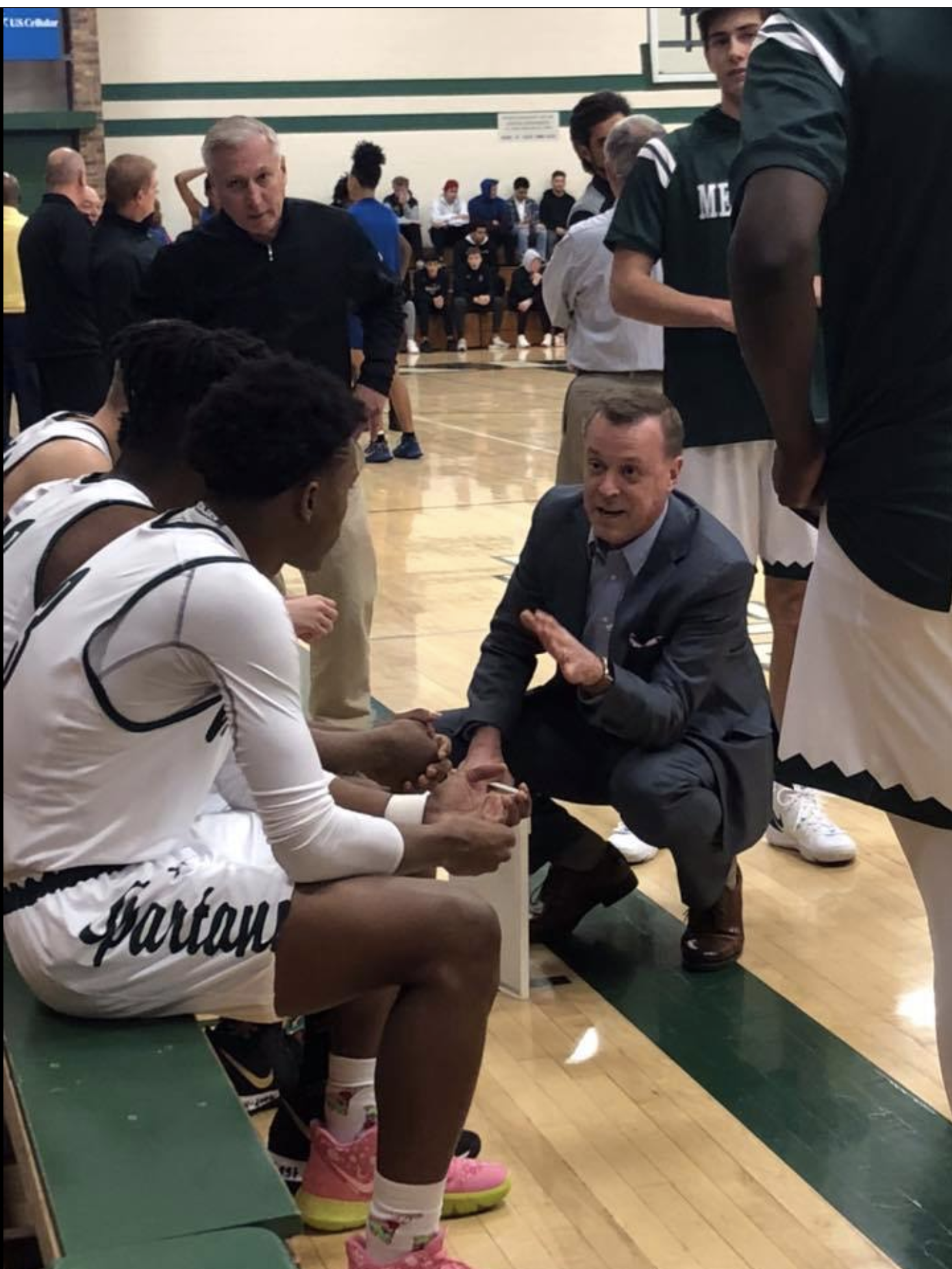 Coach and team in a huddle.