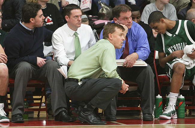 Coach watching game by the bench